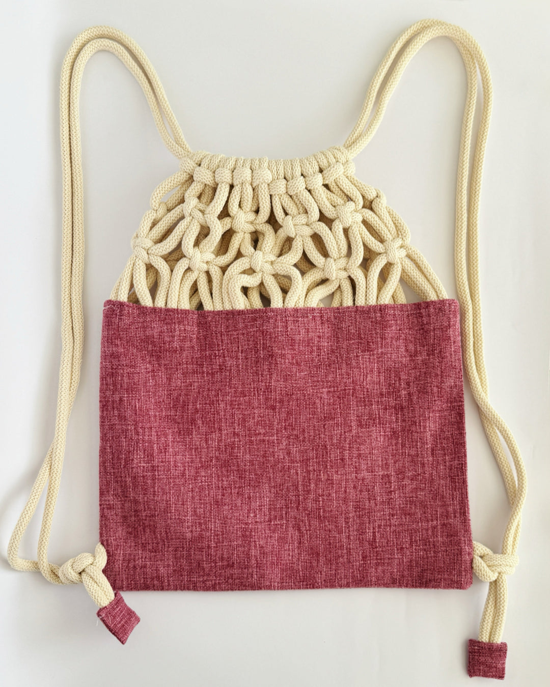Handmade macramé backpack with soft cream macramé top and rose-merlot canvas-style bottom – Tropica Merlot design, textured and elegantly natural.