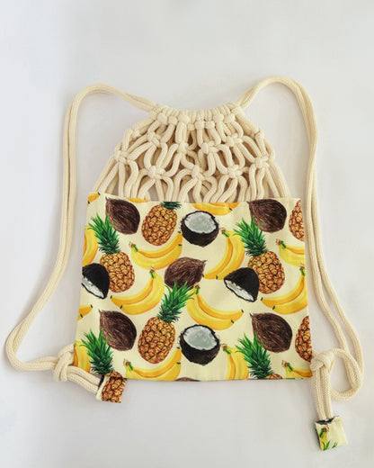 Handmade macramé backpack with soft cream macramé top and tropical fruit print canvas bottom in beige tones – Tropica Zanzibar design.